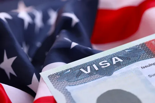 Visa document infront of a U.S. flag