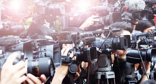 Crowd of journalists with microphones and cameras